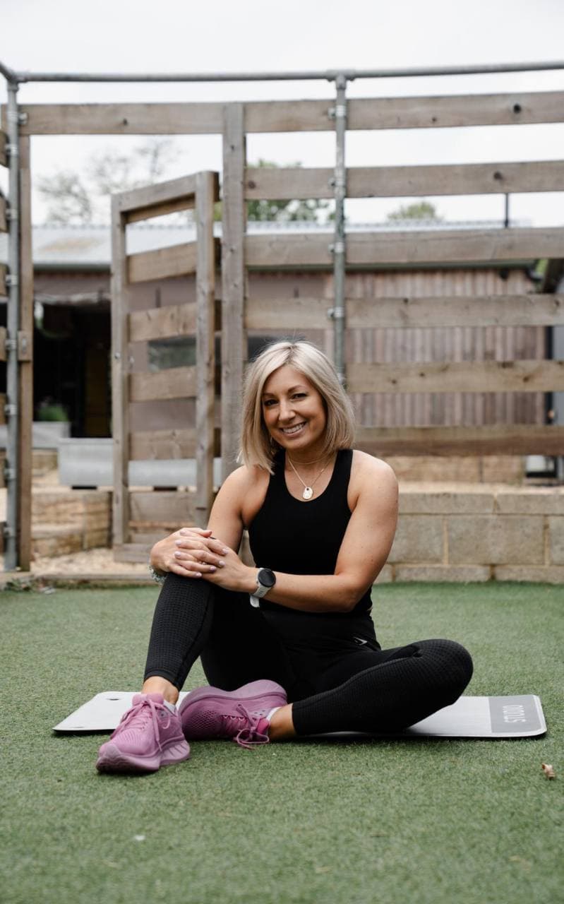 Victoria Newman, personal trainer, sitting on an exercise mat